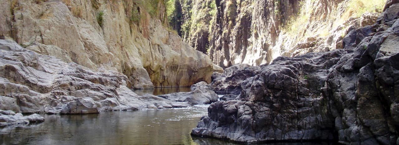 rock walls with a river stream